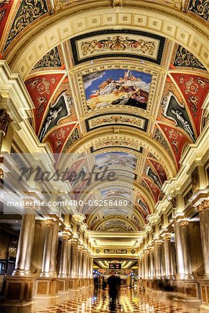 Beautiful corridor with golden decoration and painting on ceiling in luxury hotel in Macao, China.