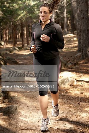 Young woman running on woods, outdoor background