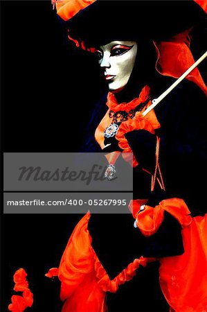 A masked woman on black background, at the Venice Carnival