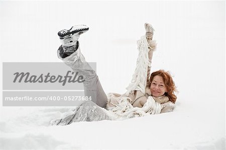 Attractive red-haired woman having fun in winters day.