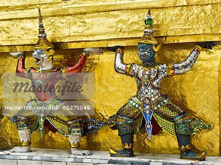 Statue of demon guardians at the Buddhist temple of Wat Phra Kaeo at the Grand Palance in Bangkok, Thailand.