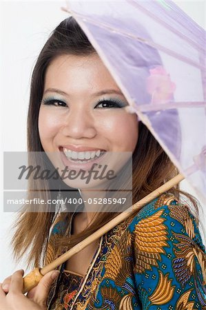 aian malay girl smiling with kebaya and umbrella