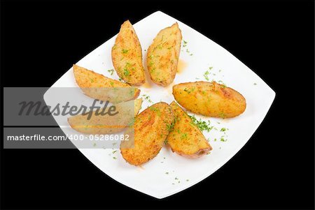 Baked potatoes with greens on a black background