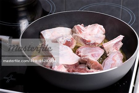 Beef sliced meat cooking in frying pan