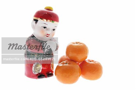 Chinese Figurine and Mandarins on Isolated White Background