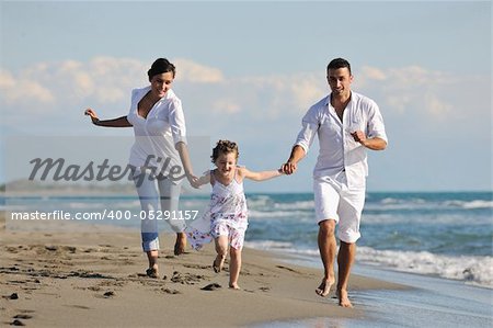 happy young family in white clothing have fun at vacations on beautiful beach