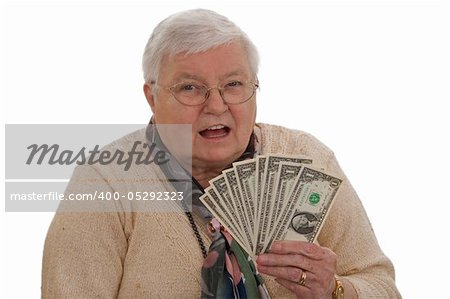 Old woman holding Dollars and laughing - isolated on white