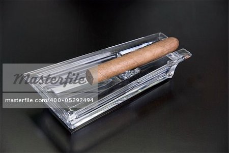 Cigar at ashtray isolated on a black back