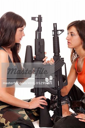 Two girls with a rifles posing to the camera