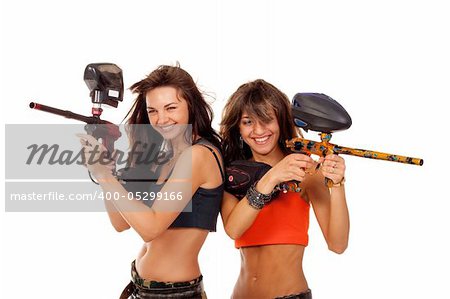 Two young beautiful girls posing like playing paintball