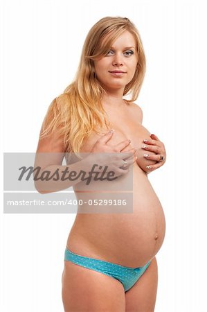 Beautiful pregnant woman standing. Closeup. Studio shoot on white