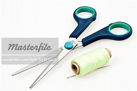 Isolated thread and scissors on white background