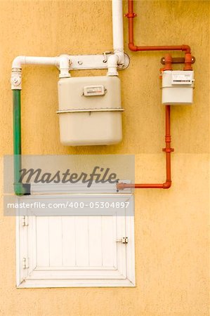 yellow wall with gas pipe and gas counter