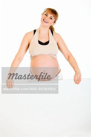 Happy beautiful pregnant woman holding blank billboard  isolated on white