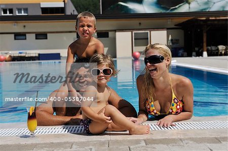 happy young family have fun on swimming pool  at summer vacation