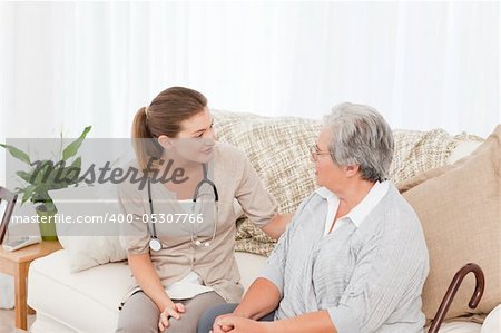 Nurse talking with her patient at home