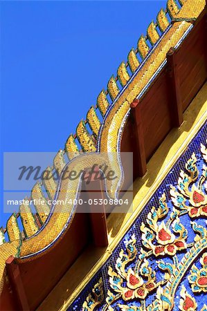 detail of ornately decorated temple roof in bangkok, thailand