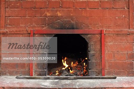 Chinese temple of fire burning in the brick stove.