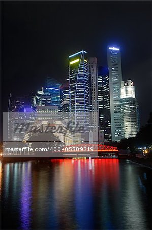 Colorful city night with skyscrapers near river in Singapore, Asia. Colorful city night with skyscrapers near river in Singapore, Asia.