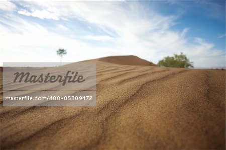 Sahara desert close to Merzouga in Morocco with blue sky and clouds