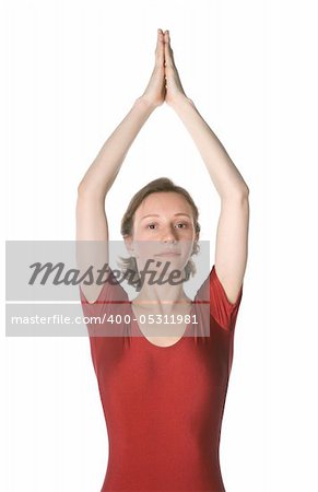 Woman in a red leotard exercising over white background