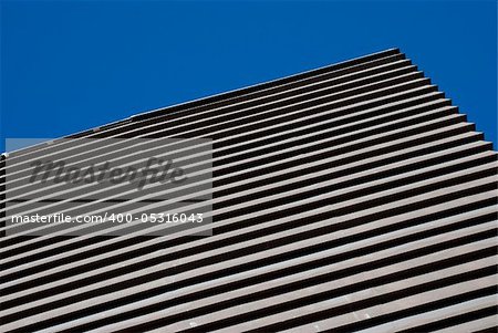 Abstraction of curves for modern building on a clear blue sky.