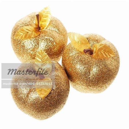 Golden apples lying on a white background
