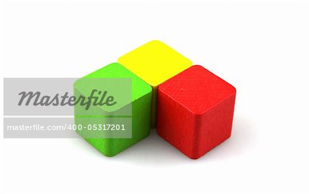 Wooden building blocks on white background. Close Up.