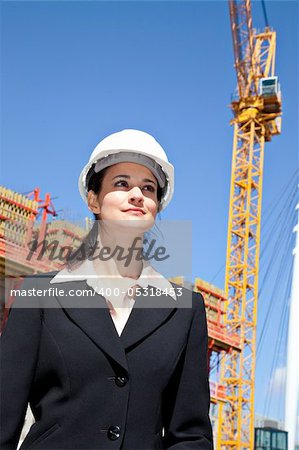 Woman on job site with crane in background