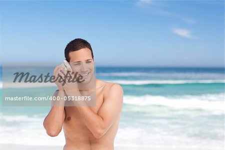 Man listening to his shell