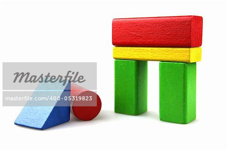 Wooden building blocks on white background. Close Up.