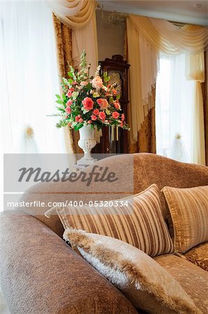 bouquet of beautiful flowers in the vase near the window