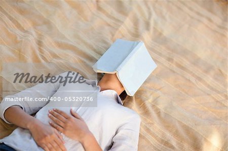 Woman sleeping with her book