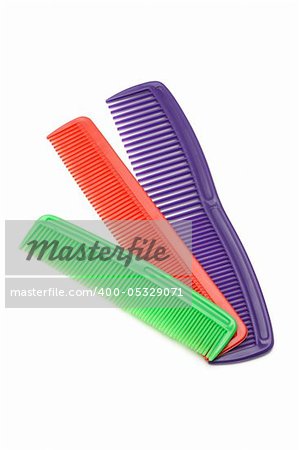 Three colorful plastic combs on white background