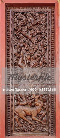 Decorated wooden beside door in Buddhist temple, Laos