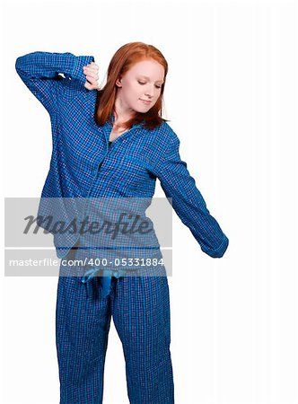 A young stretching woman waking up in her pajamas in the morning