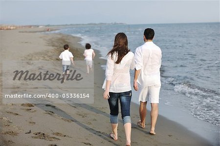 happy young family have fun and live healthy lifestyle on beach