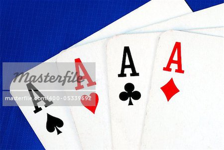 Four ace play cards isolated on blue