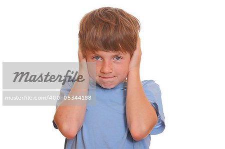 Portrait of a young boy covering his ears on white background
