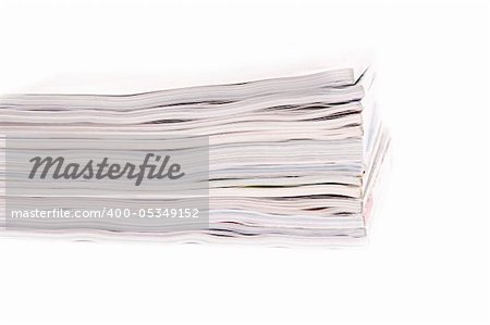 Closeup of a pile of magazines on white background