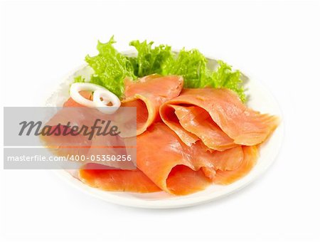 smoked salmon slices and vegetables on a white plate