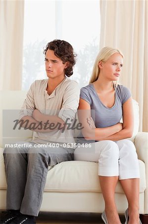Portrait of a couple after an argument with the arms crossed