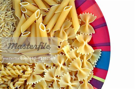 Colorful plate with pasta variety. Creative food on white background.