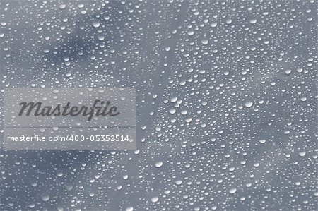 Raindrops on transparent plastic background texture. Selective focus.