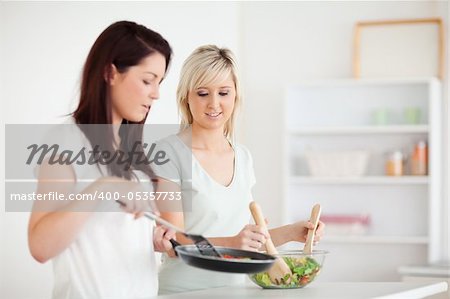 Beautiful Women cooking dinner in a kitchen