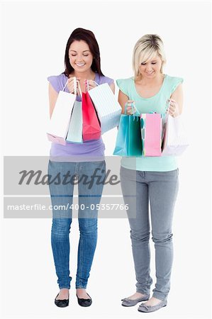 Cute women with shopping bags in a studio