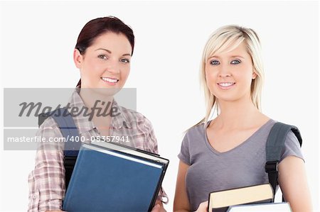 Close up of College students holding books in a studio
