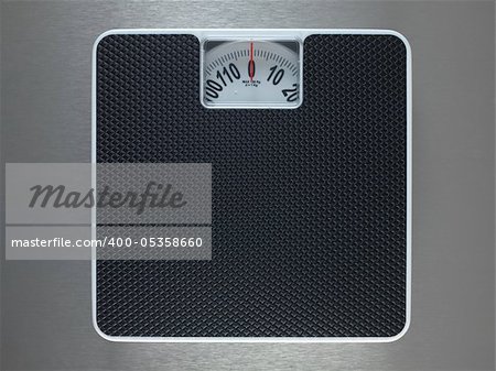 Bathroom scales isolated against a metallic background