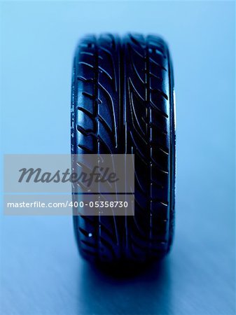 Rubber tyres with sports rims on a silver background