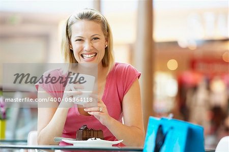 Woman Eating A Piece Of Cake At The Mall